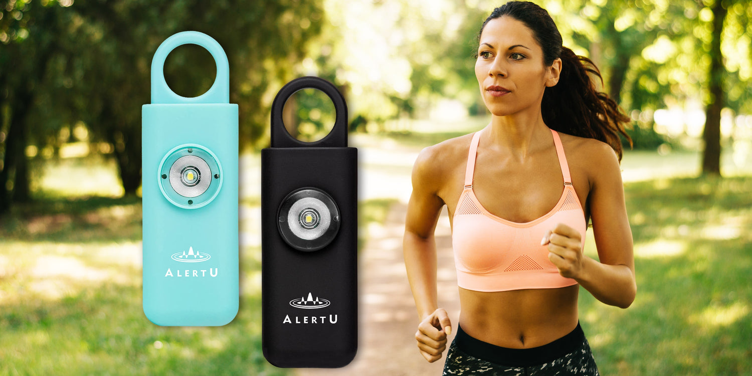 Banner of a woman running alone in a park in running attire with blue and black pull pin self defense alarms on the image